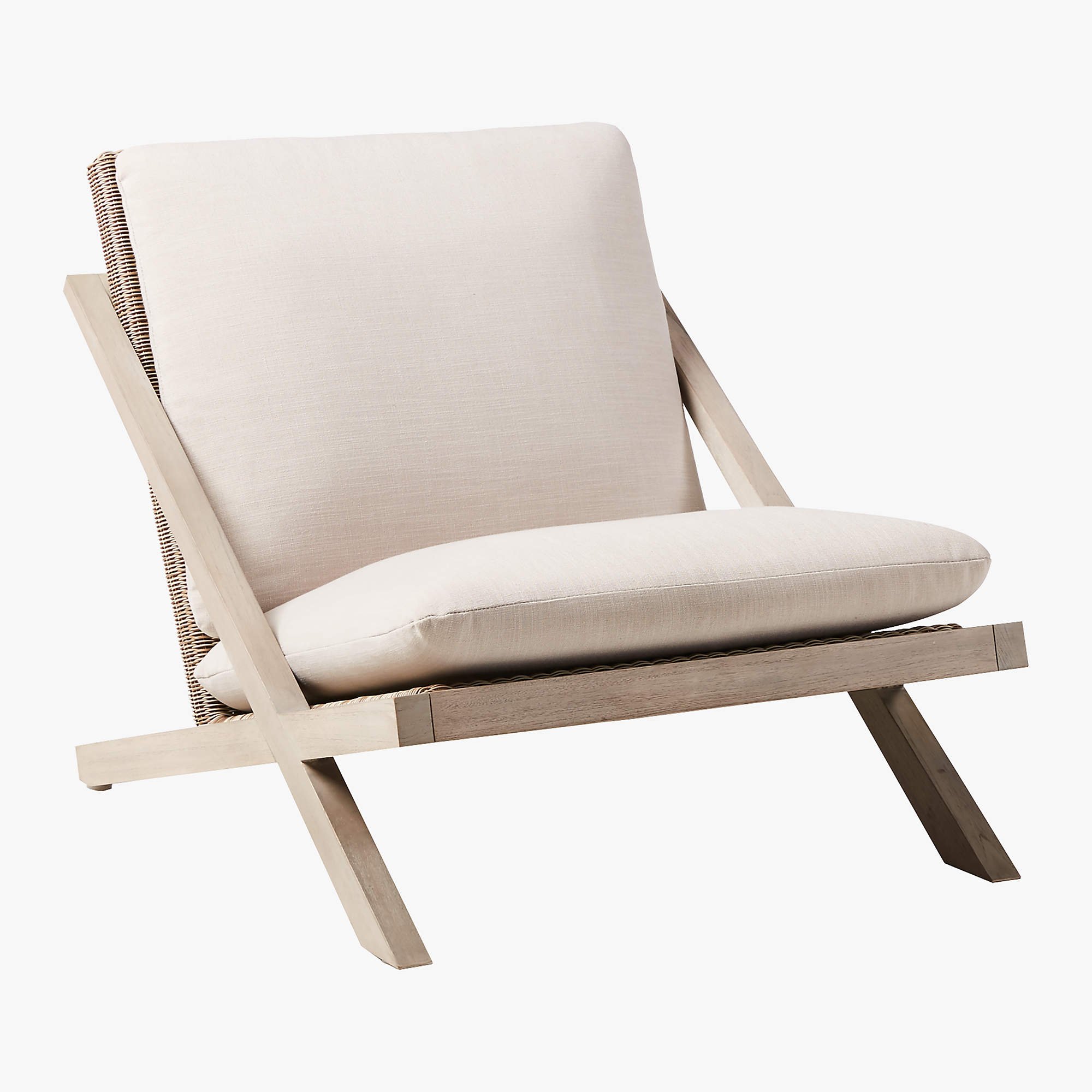 Lecco teak outdoor chair with sand colored cushions is low to the ground and laid back