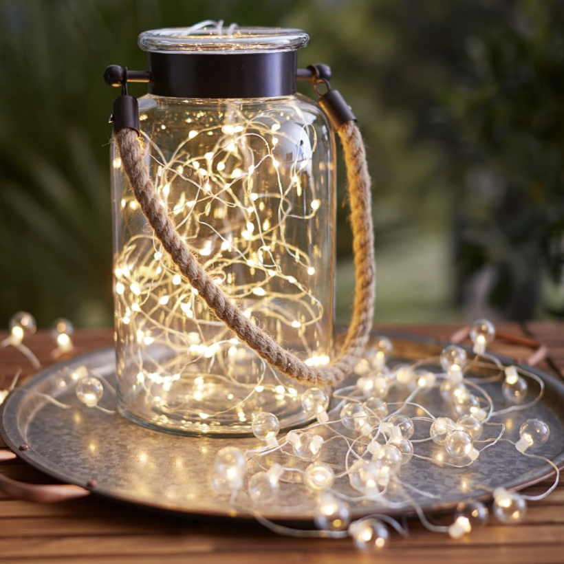 07                                   Mini LED String Lights - Add a festive ambiance to your outdoor gathering spaces by wrapping tree trunks and branches in Pottery Barn’s flexible mini LED string lights. Battery powered; these sparkly lights make it easy to add outdoor lighting and brighten up every corner of your yard. They’re also eco-friendly, and last up to 80 hours on a single AAA battery charge. SHOP NOW >