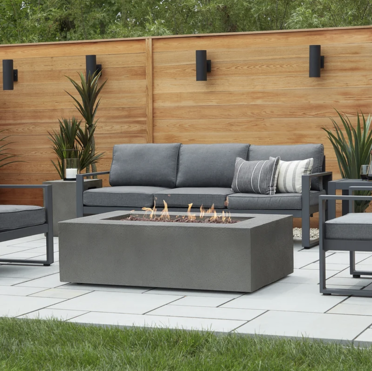 Baltic Concrete Fire Pit  - The concrete finish of this rectangular propane gas fire pit table will blend well with warm, modern landscaping. Spacious at more than four feet long, there’s plenty of room for everyone to gather around—and with a 65000 BTU output, plenty of heat as well. SHOP NOW >