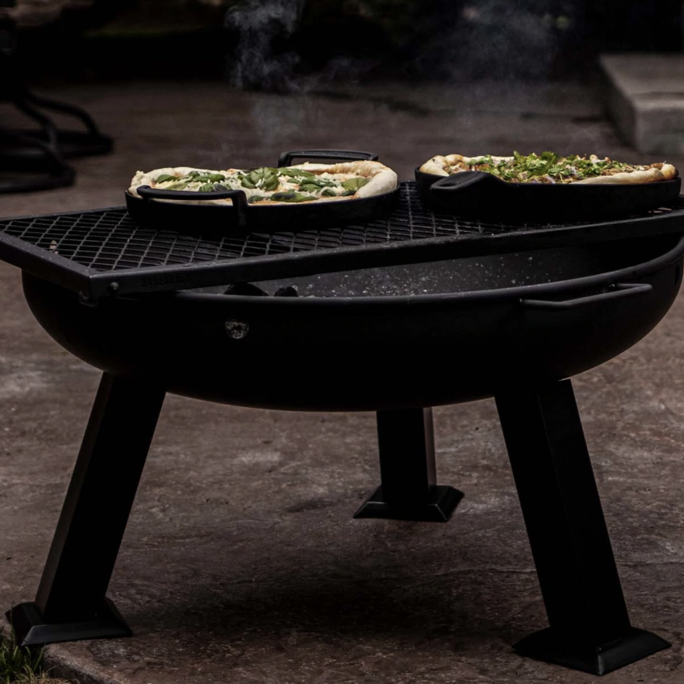 Barebones Living Fire Pit - Barebone’s stainless steel wood burning fire bowl is built for durability but is lighter than cast iron. This makes it the perfect portable fire pit, going effortlessly from a bbq at the campground to warming up in your backyard. But it’s equally cool—with its sleek black finish, solid legs and a pair of handles—all for toasting marshmallows or just getting toasty. SHOP NOW >