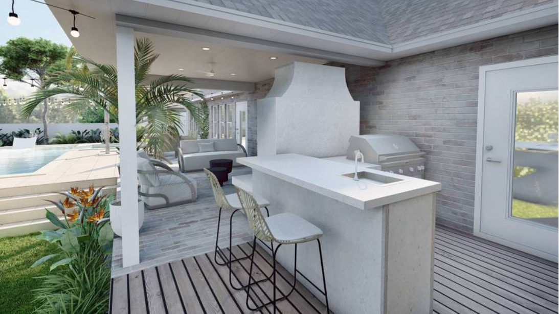 Partial outdoor kitchen design for Santa Rosa Beach, FL home that is tucked behind an outdoor fireplace and includes sink on bar seating and a built-in grill.