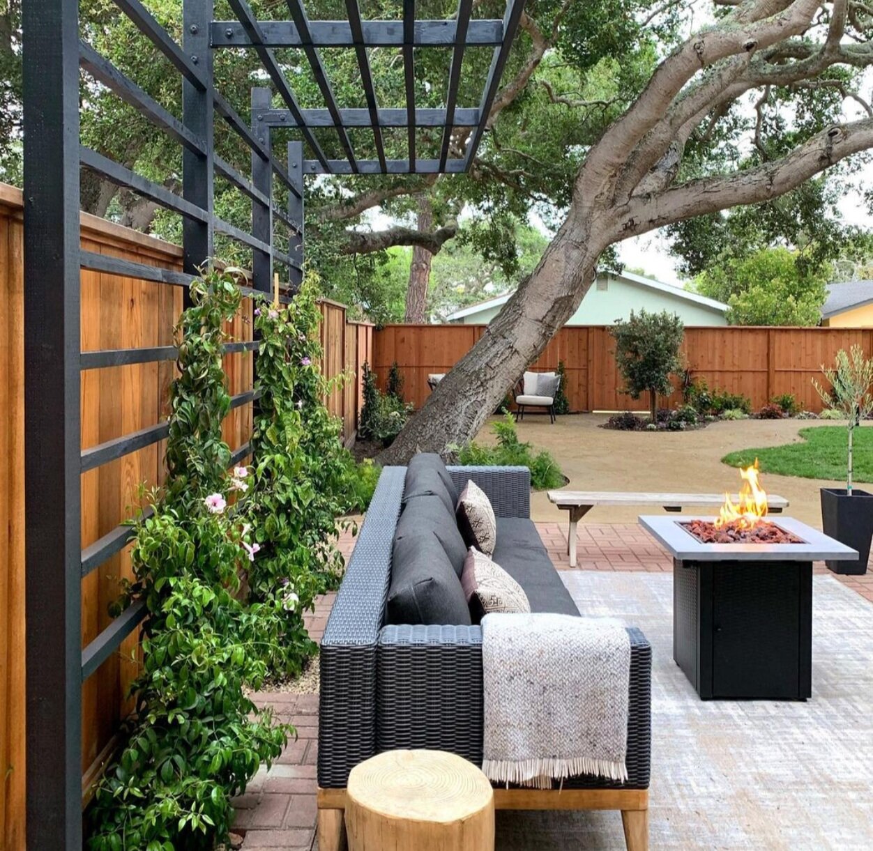 Yardzen backyard patio with brick pavers, fire pit, and patio furniture via @kismet_house