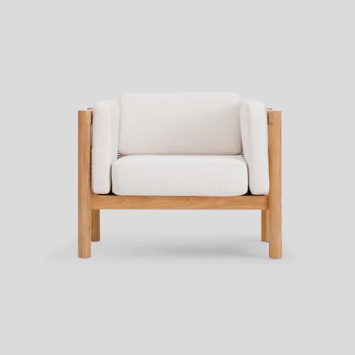 Round legged teak outdoor chair with white cushions.