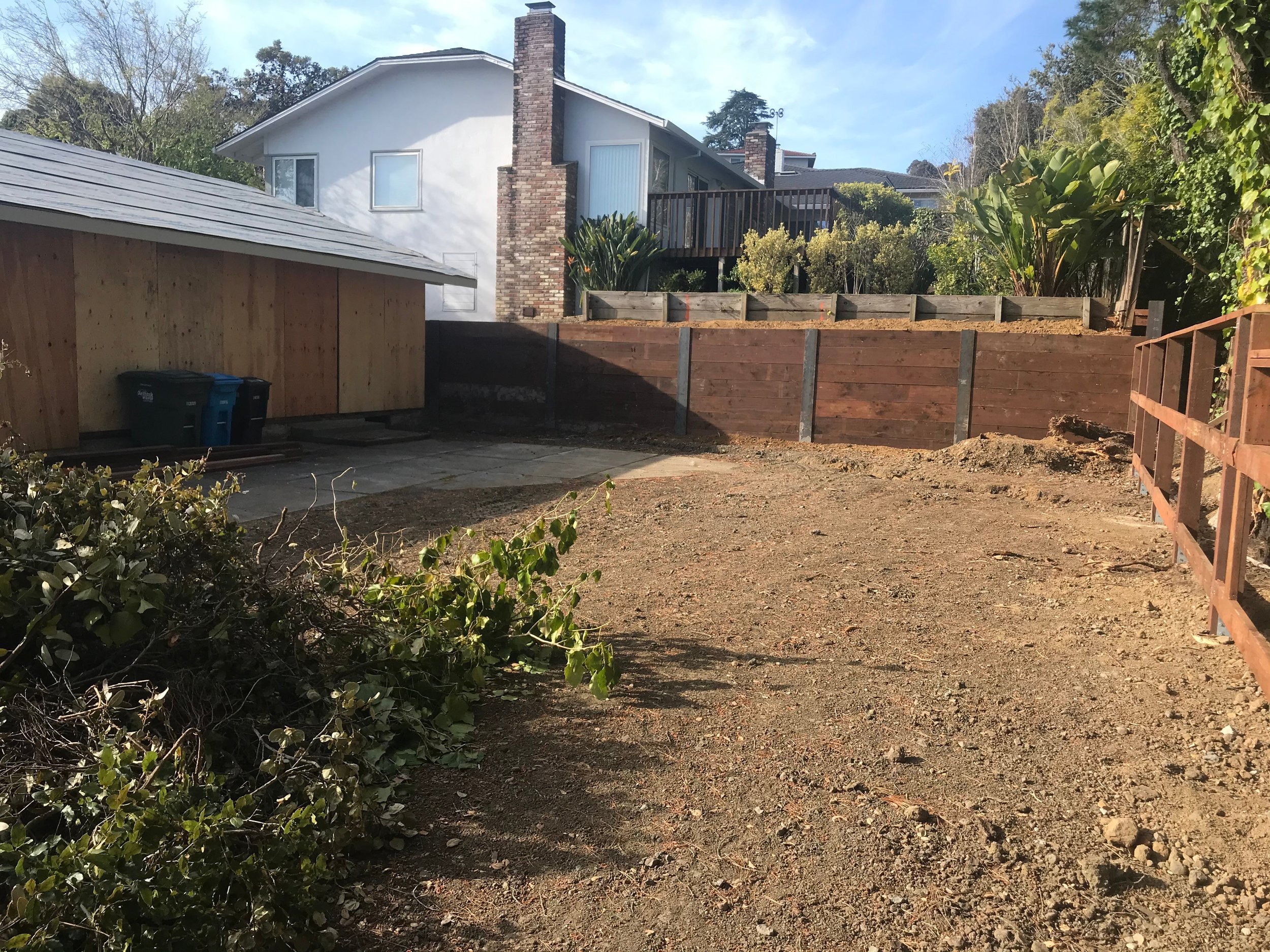 the backyard during renovation, just after a new retaining wall was put in to level the backyard