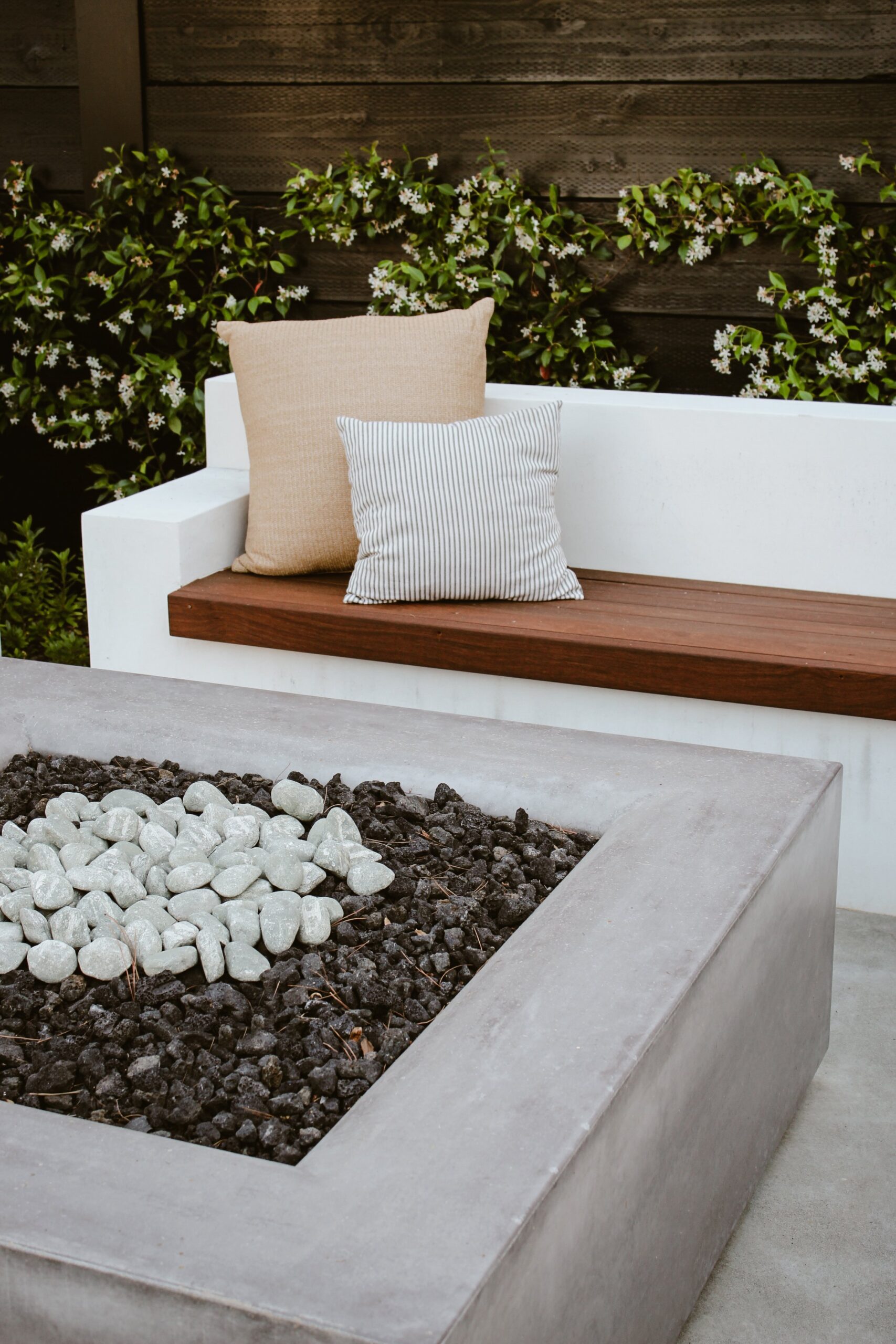 Close up of modern square fire pit with black and grey stones